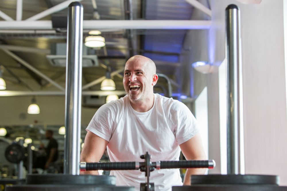 A man using the sled track, smiling