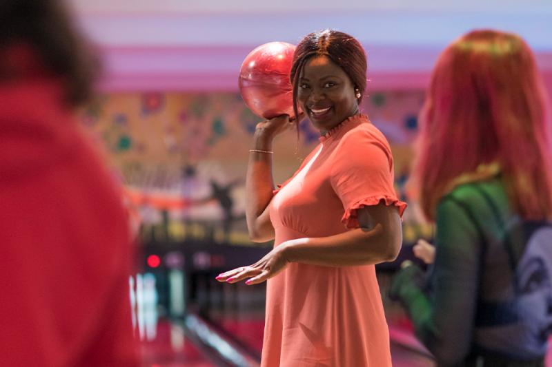 Adults having fun at a bowling alley