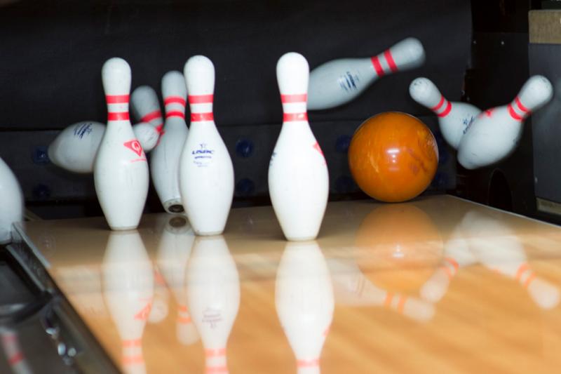 Ball hitting pins at a bowling alley