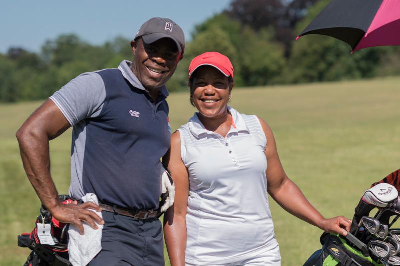 A couple out enjoying golf on the golf course