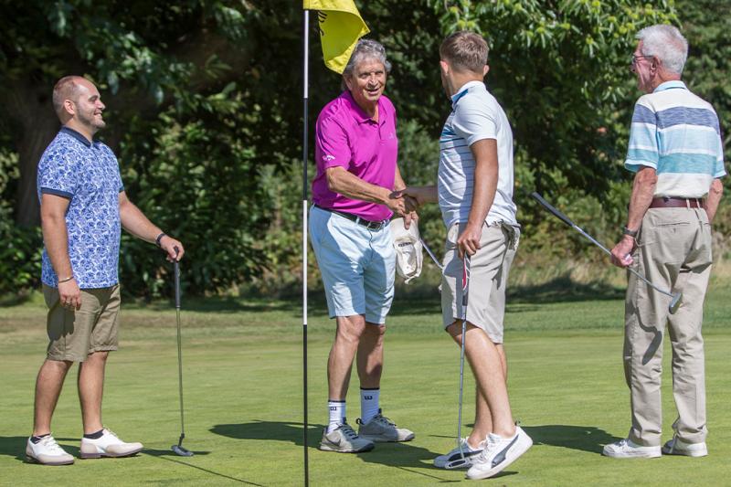 Golfers congratulating each other after game of golf