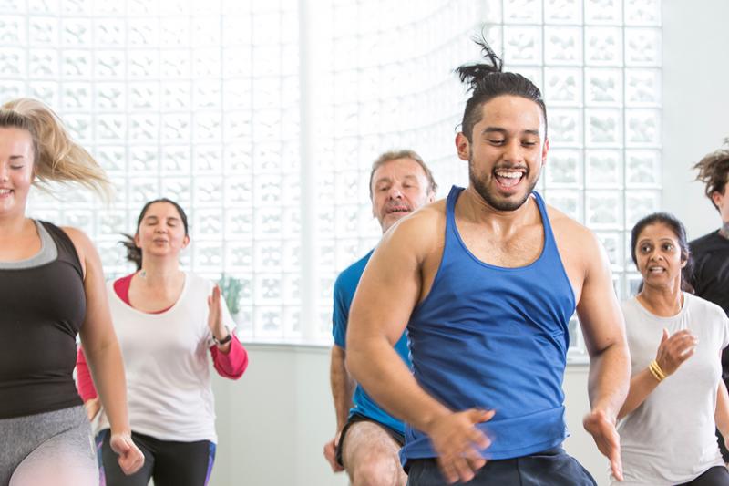 People smiling in a group exercise class