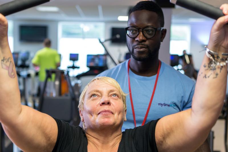 Primetime member with instructor in the gym