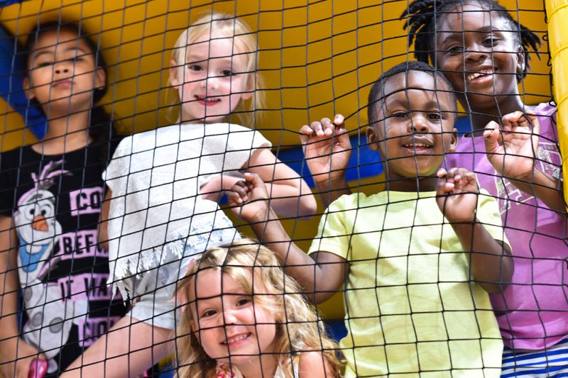 Children looking through the side of the Buzz Zone soft play climbing frame