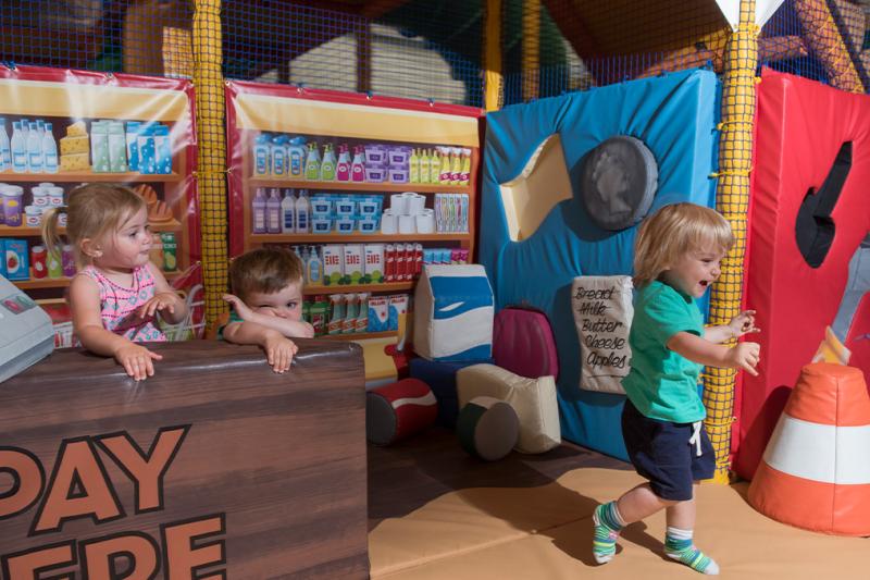 Children playing shop in the Buzz Zone soft play centre