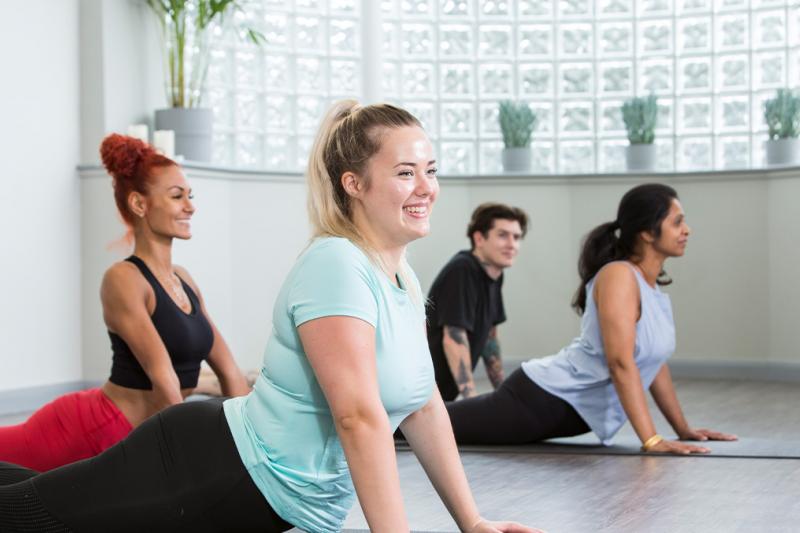 Group smiling at a yoga class