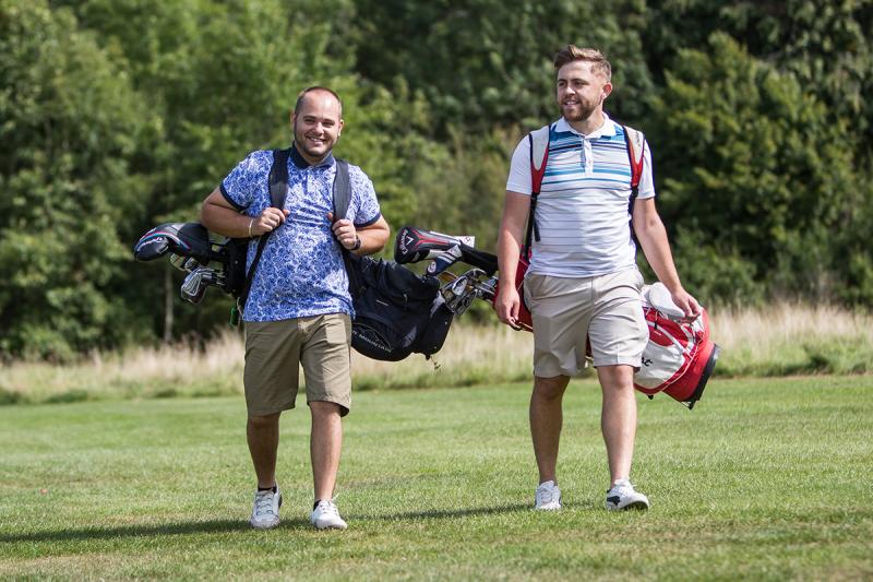 Two men playing golf